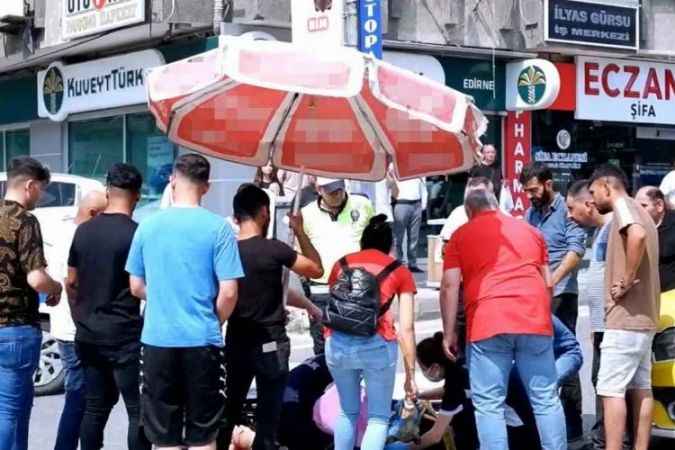 Yaralıyı marketten aldığı şemsiye ile  korudu